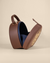 Plum-colored sling bag with animal embroidery, gold zari work, and hand bead detailing