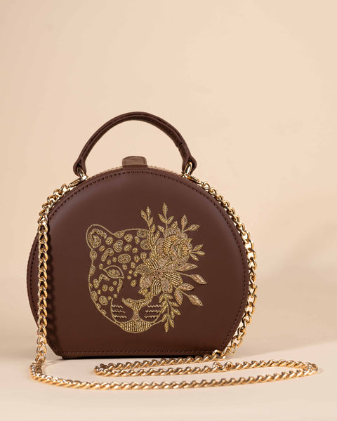 Plum brown sling bag with leopard face embroidery, golden zari, and nakshi handwork