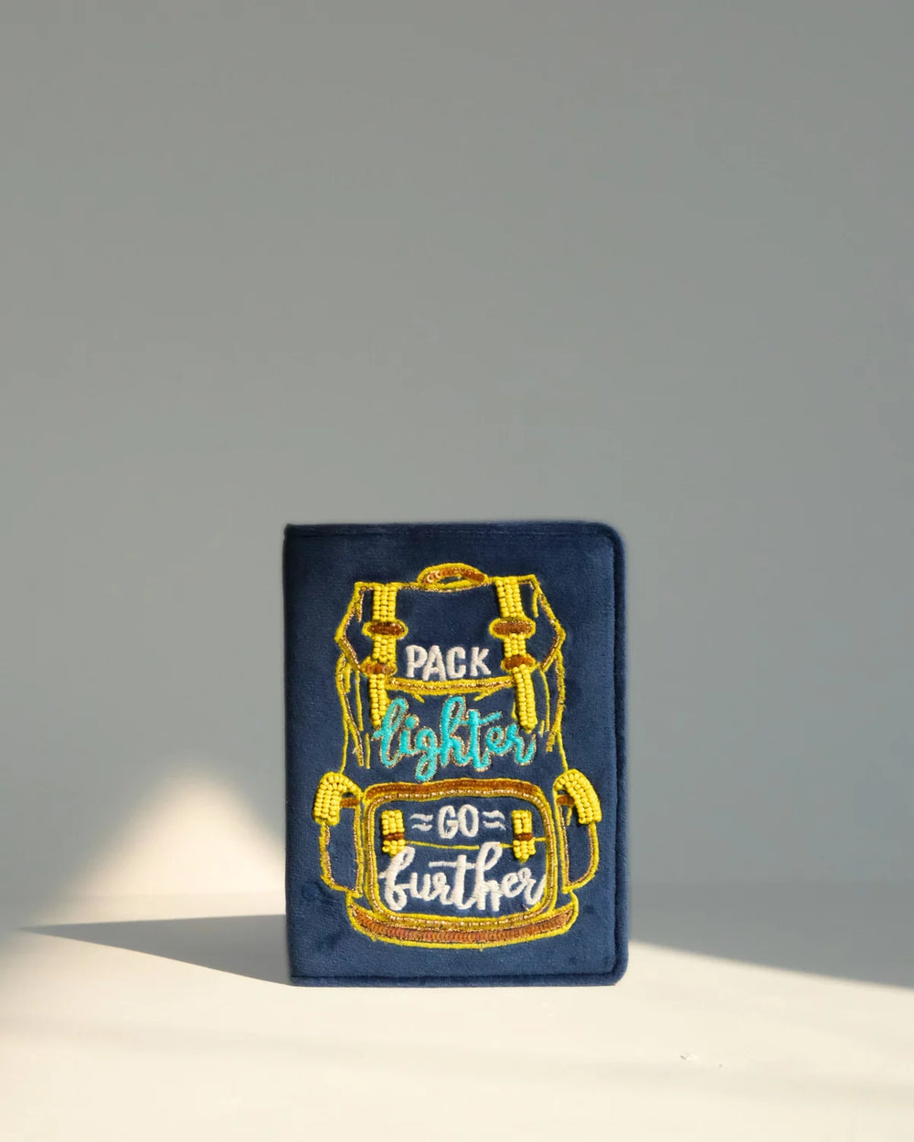 Embroidered patch with a backpack design and text on a blue background