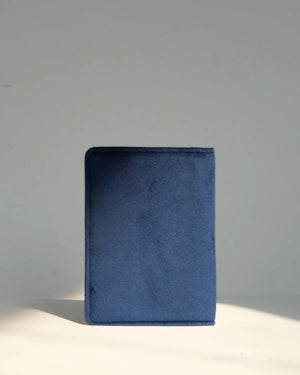 Blue fabric book on a gray background