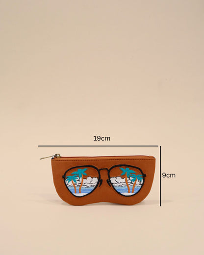 Brown  sunglasses cover with embroidered tropical scenery featuring palm trees, ocean waves, and clouds, creating a vacation-inspired design.