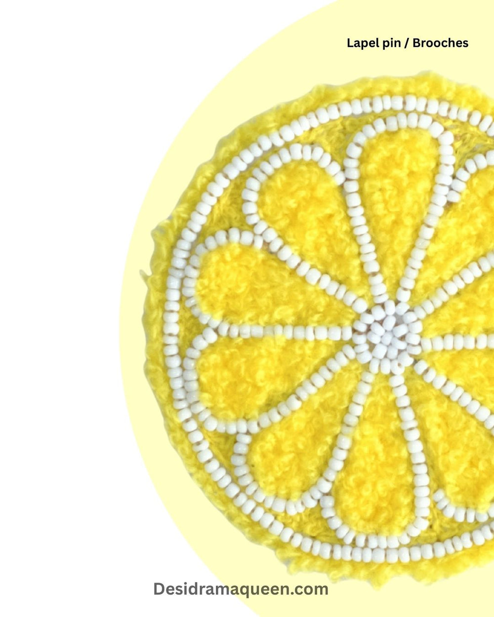 Yellow embroidered lemon slice brooch with white bead detailing, quirky handmade fruit accessory for jackets and bags.