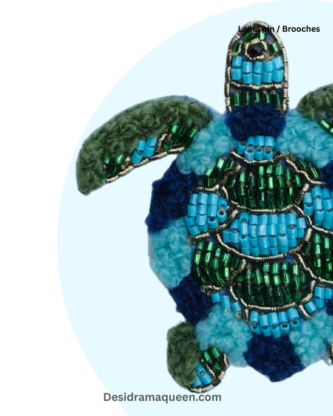 Unique turtle brooch handcrafted with aqua blue, navy, and green beadwork, perfect accessory for ocean lovers.