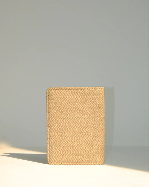 Beige woven notebook on a light gray background