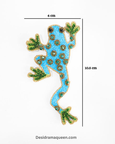 Handmade frog brooch with green bead accents and sequins