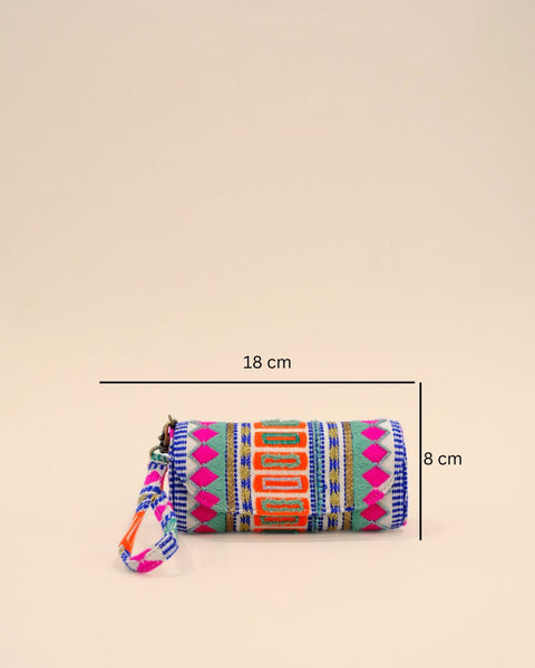 Text: Cylindrical sunglass cover with a wrist strap, featuring vibrant bohemian embroidery in pink, orange, blue, and green geometric patterns for a bold and stylish look.