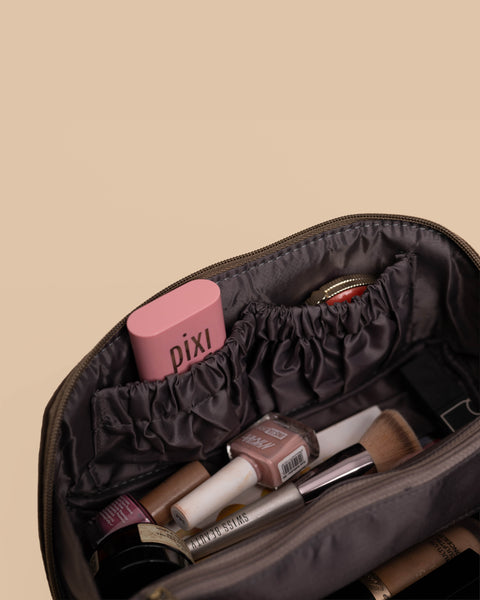Stylish brown pouch embroidered with moon, sun, and star patterns, ideal for makeup and toiletries.