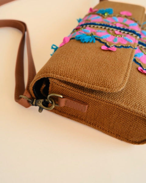 Bohemian style sling bag with floral embroidery and tassel details