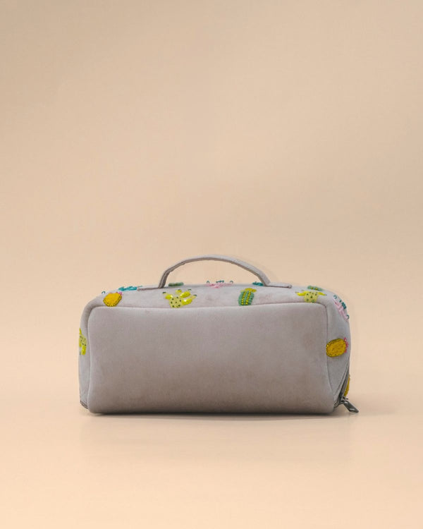 Back view of the Cactus Sand Shell Makeup Pouch crafted from premium light grey fabric with a clean minimalist finish, sturdy carry handle, and roomy zippered design for everyday use