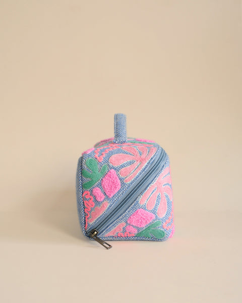 Elegant pastel embroidered makeup organizer with zipper and handle, stylish cosmetic pouch.