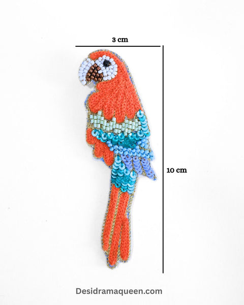 Red and turquoise embroidered parrot brooch with bead details
