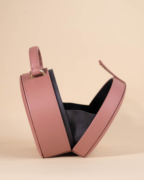 Peach-colored luxury sling bag with evil eye embroidery, crystal accents, and dabka-katdana detailing