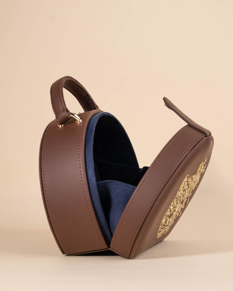 Leopard-themed sling bag with gold zari embroidery and handcrafted bead accents