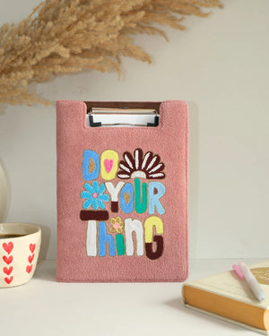 Pink clipboard with 'Do Your Thing' text on a light background