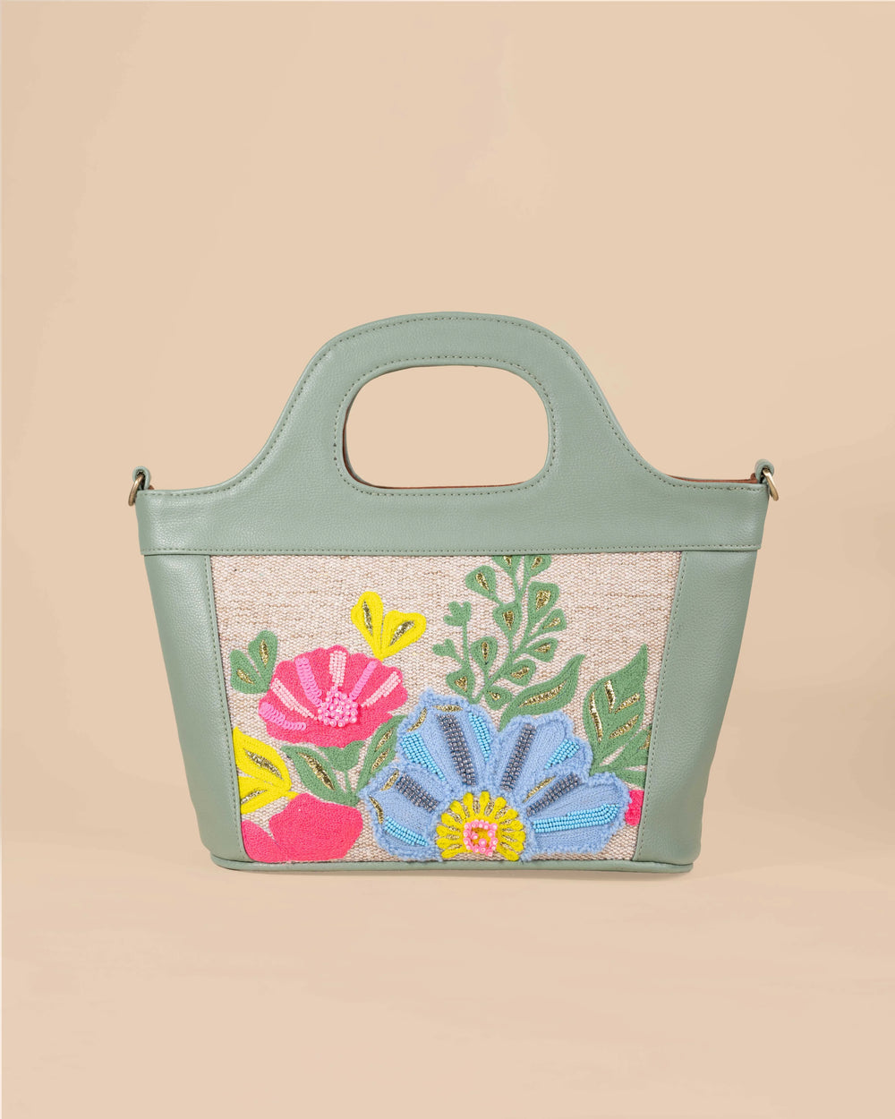 Handbag with floral embroidery on a beige background