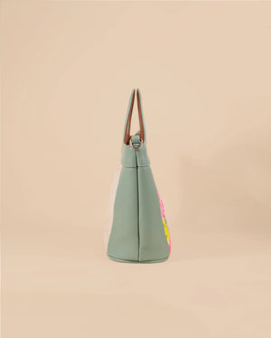 Green tote bag with floral design on a beige background