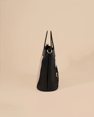 Black handbag on a beige background