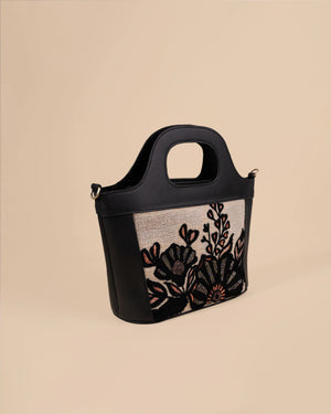 Handbag with floral embroidery on a beige background