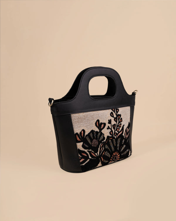 Handbag with floral embroidery on a beige background