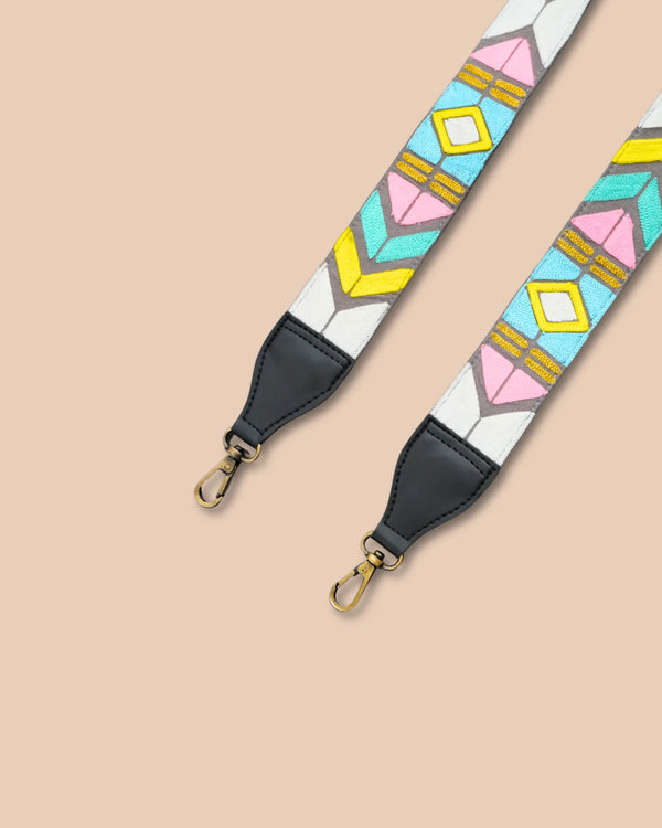 Colorful geometric patterned strap with black ends on a beige background