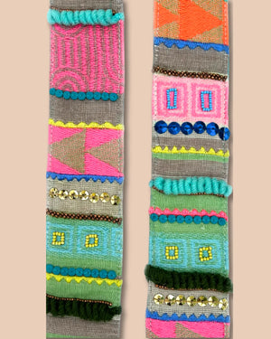 Colorful woven belt with geometric patterns on a beige background