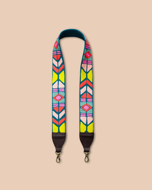 Colorful patterned strap with brown accents on a beige background