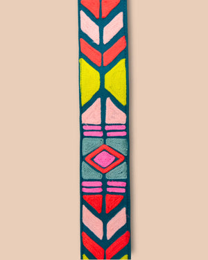 Colorful geometric patterned strap on a beige background