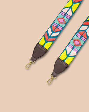 Colorful geometric patterned strap with brown leather ends on a beige background