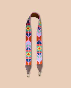 Colorful geometric-patterned strap on a beige background