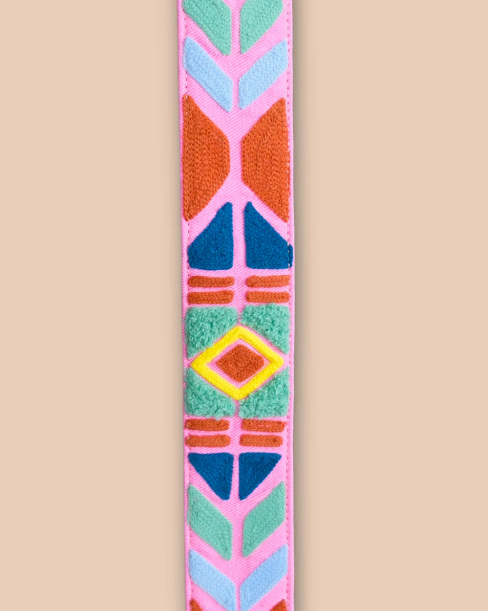 Colorful geometric-patterned strap on a beige background