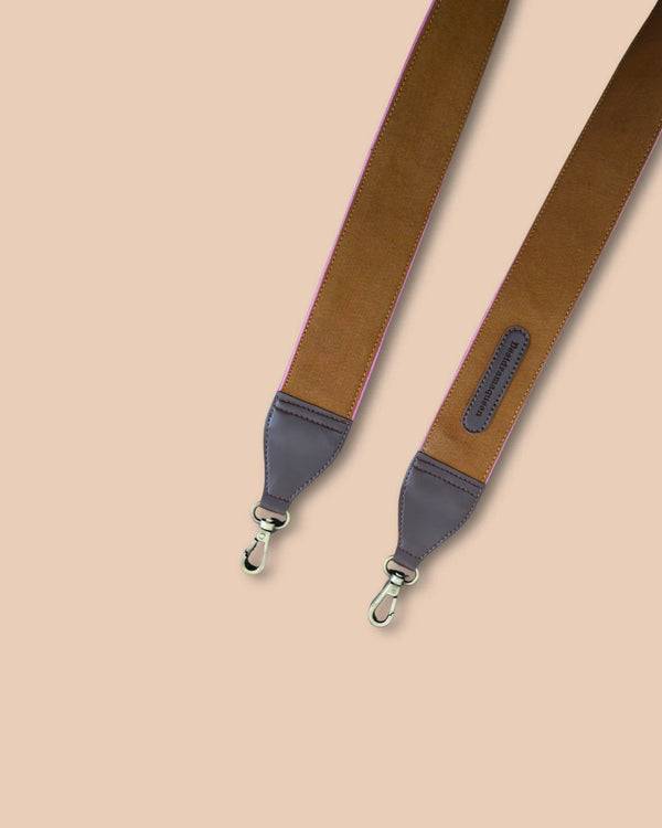 Brown leather strap with gray accents on a beige background