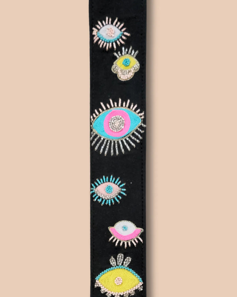 Floral patterned strap with gray ends on a beige background