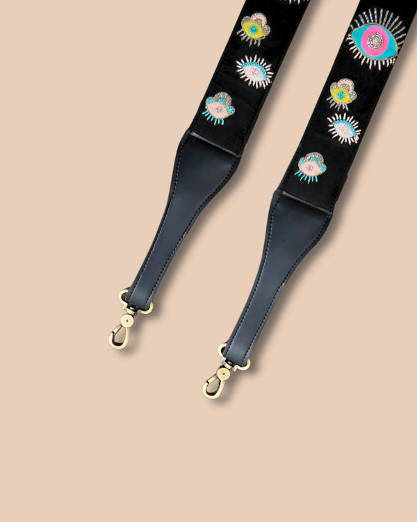 Leather strap with floral embroidery on a beige background