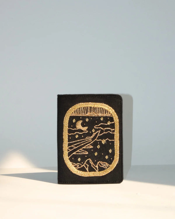 Black notebook with gold embossed design on a light gray background