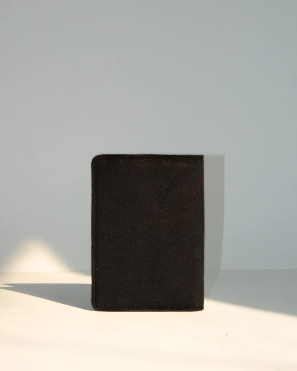 Black textured book on a light gray background