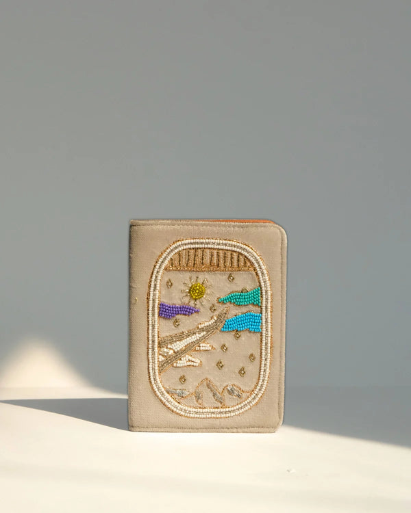 Decorative pouch with beadwork on a neutral background