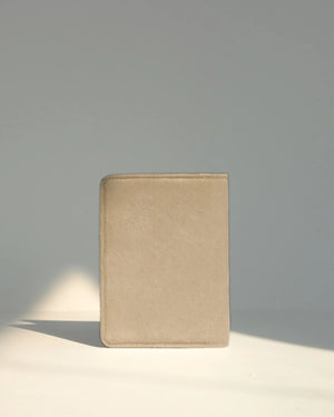 Beige leather wallet on a light gray background