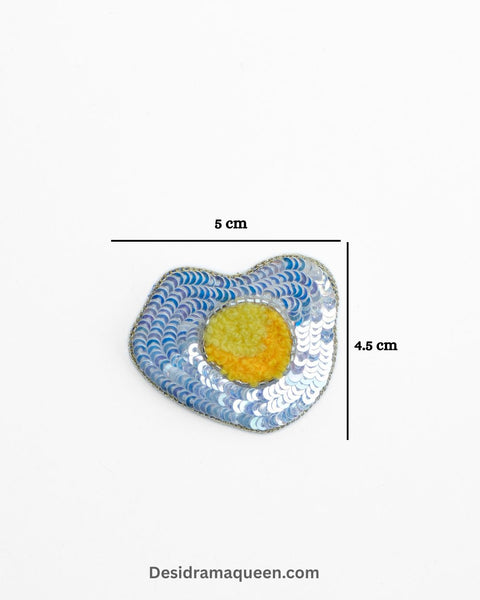 Handmade brooch shaped like fried egg with yellow yolk