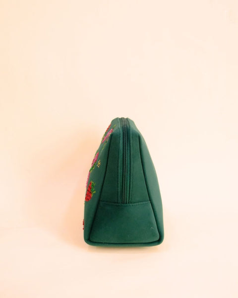 Green makeup pouch with strawberry embroidery and pink tassel zipper, handmade cosmetic bag for quirky fashion lovers.