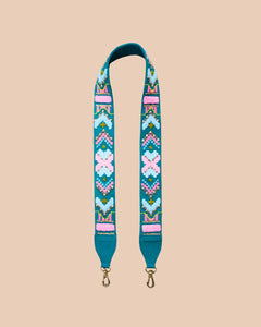 Decorative bag strap with colorful pattern on a beige background