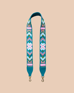 Decorative bag strap with colorful pattern on a beige background