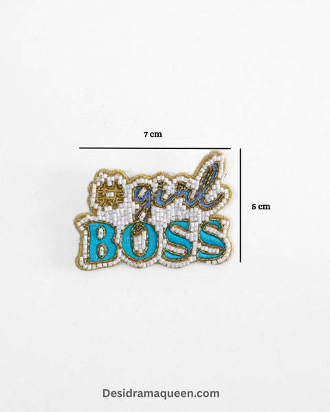 White and turquoise brooch with #GirlBoss embroidery