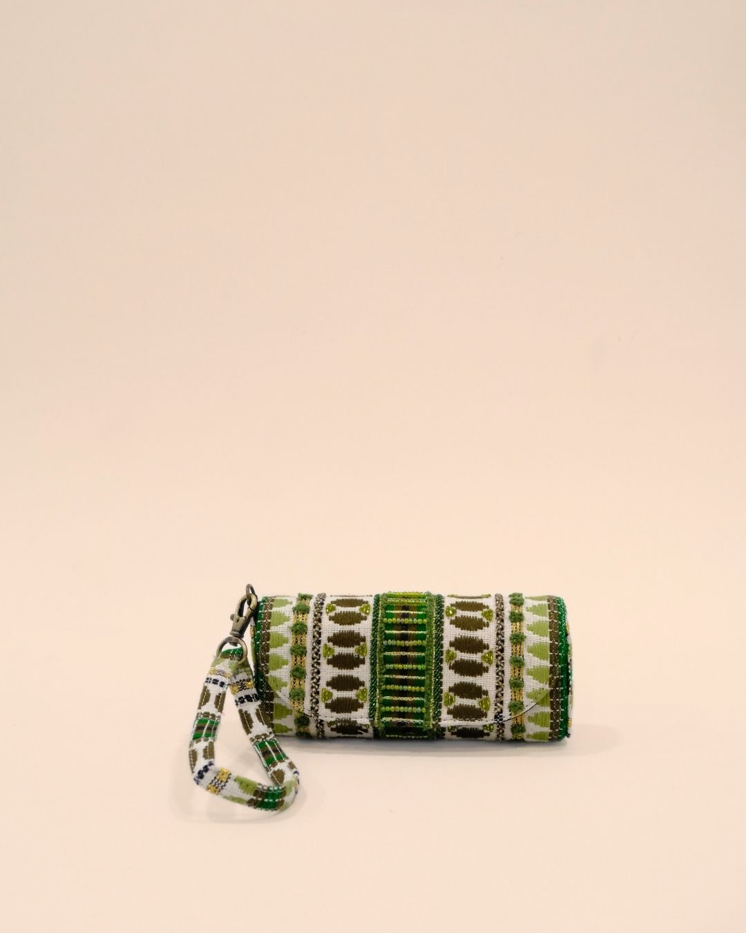 Handmade sunglass cover with tribal embroidery in green, olive, and gold on white base, featuring a matching wrist strap.