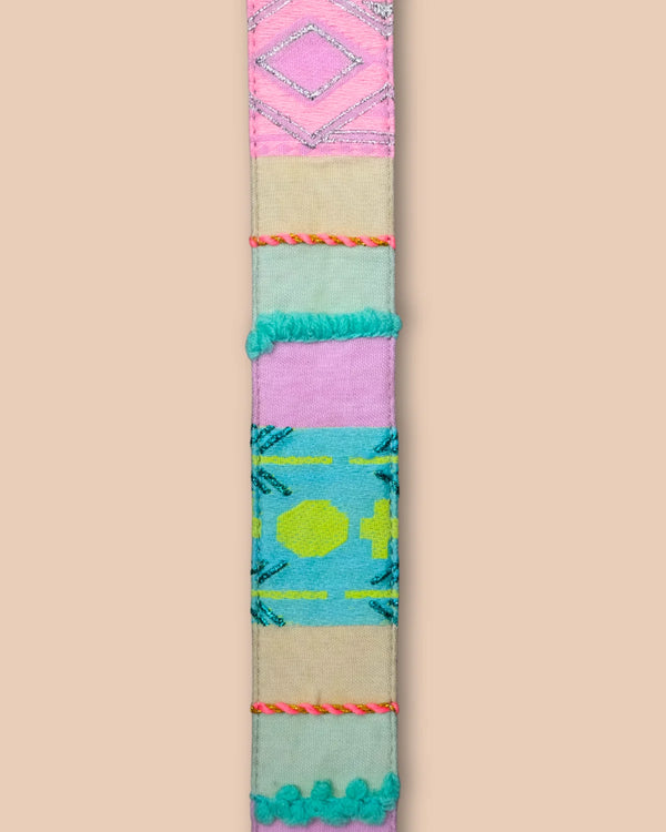 Colorful patterned belt on a beige background