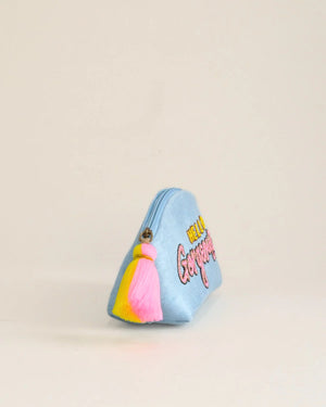 Small blue pouch with colorful accents and text on a beige background