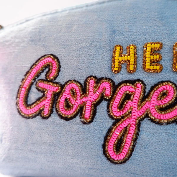 Text with 'HE' in yellow, 'Gorge' in pink on a textured surface