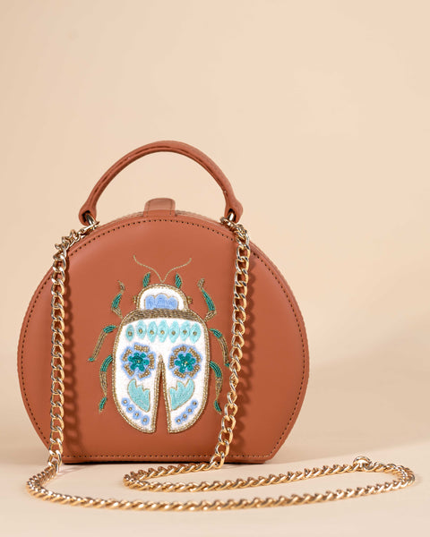 Bug-themed box sling featuring sea green and gold dabka, gold beads, and sequin accents