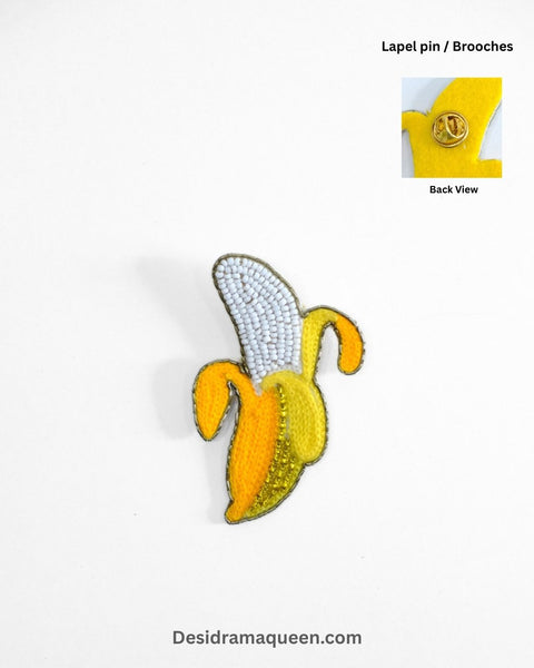Handmade banana brooch with yellow embroidery and beadwork, quirky fruit lapel pin for jackets, shirts, and bags.