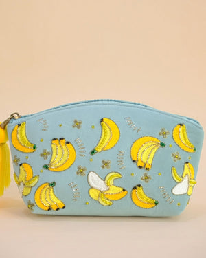Pastel blue pouch featuring embroidered banana motifs with beads and tassel zipper, handmade makeup bag for accessories and toiletries.