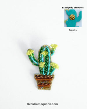 Handcrafted cactus brooch with green and yellow bead embroidery in a brown beaded pot, unique lapel pin design.
